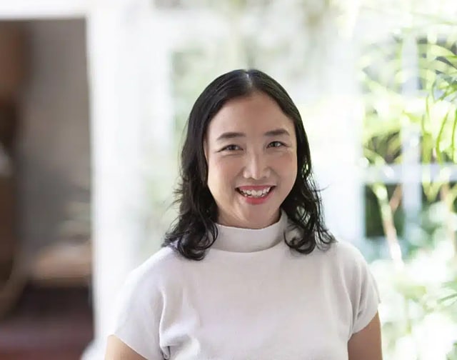 Portrait of The Place Retreats' in-house psychiatrist smiling in a bright indoor setting