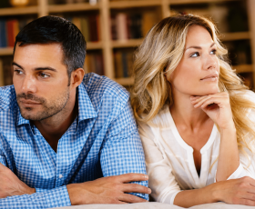 Contemplative Couple Leaning Together in Home Setting